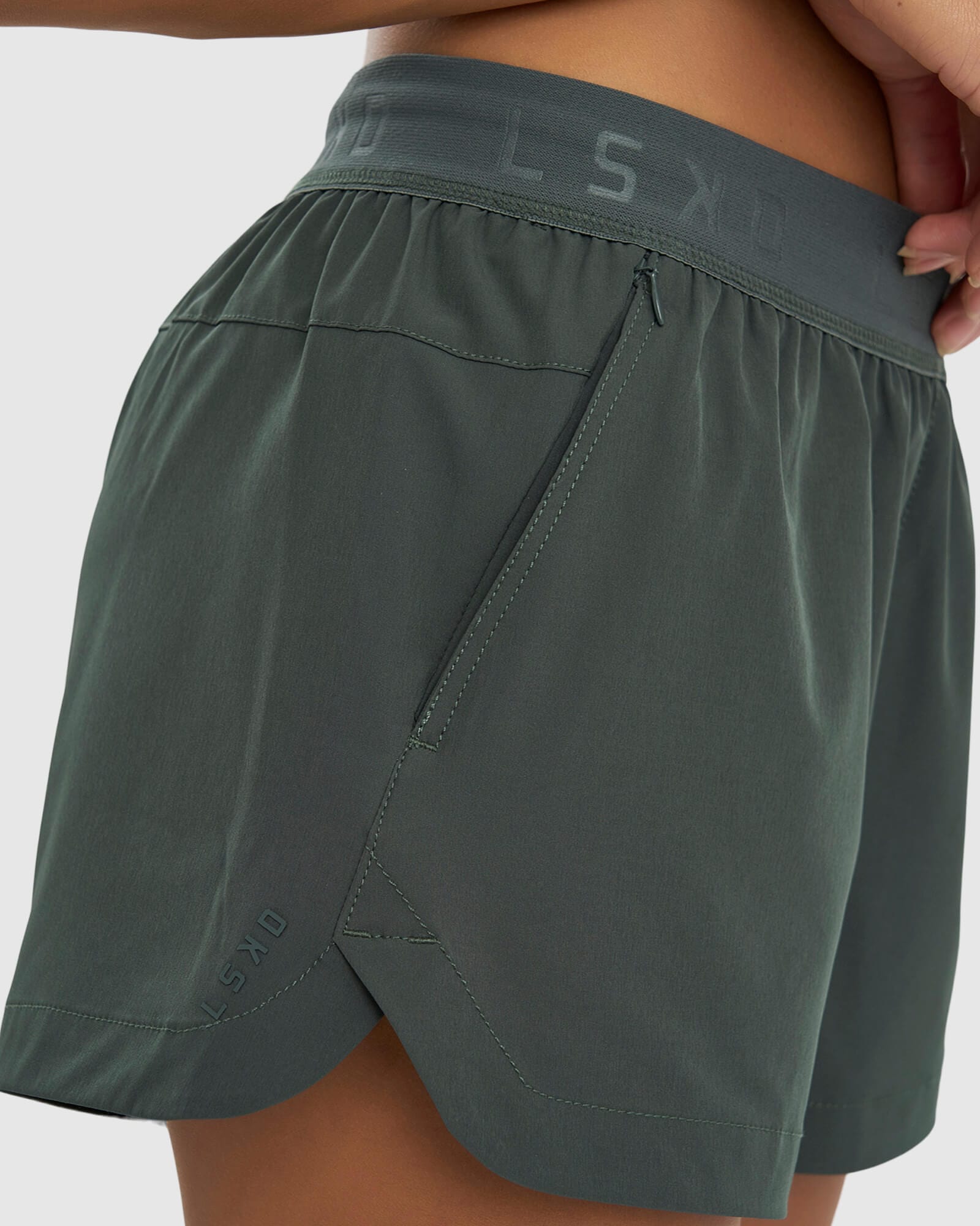 Model wearing Competition Performance Short - Carbon Green