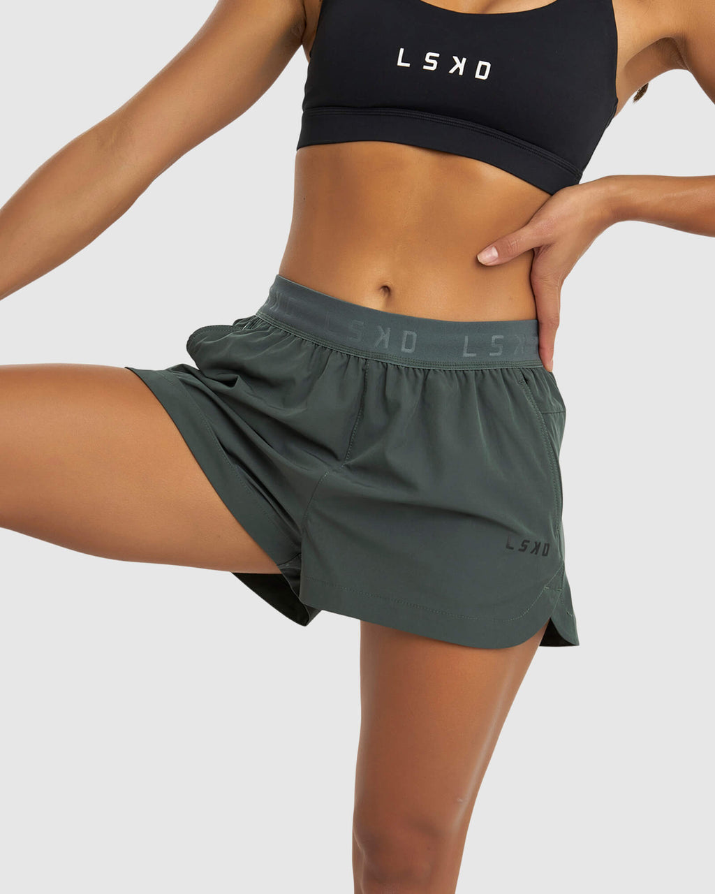 Model wearing Competition Performance Short - Carbon Green