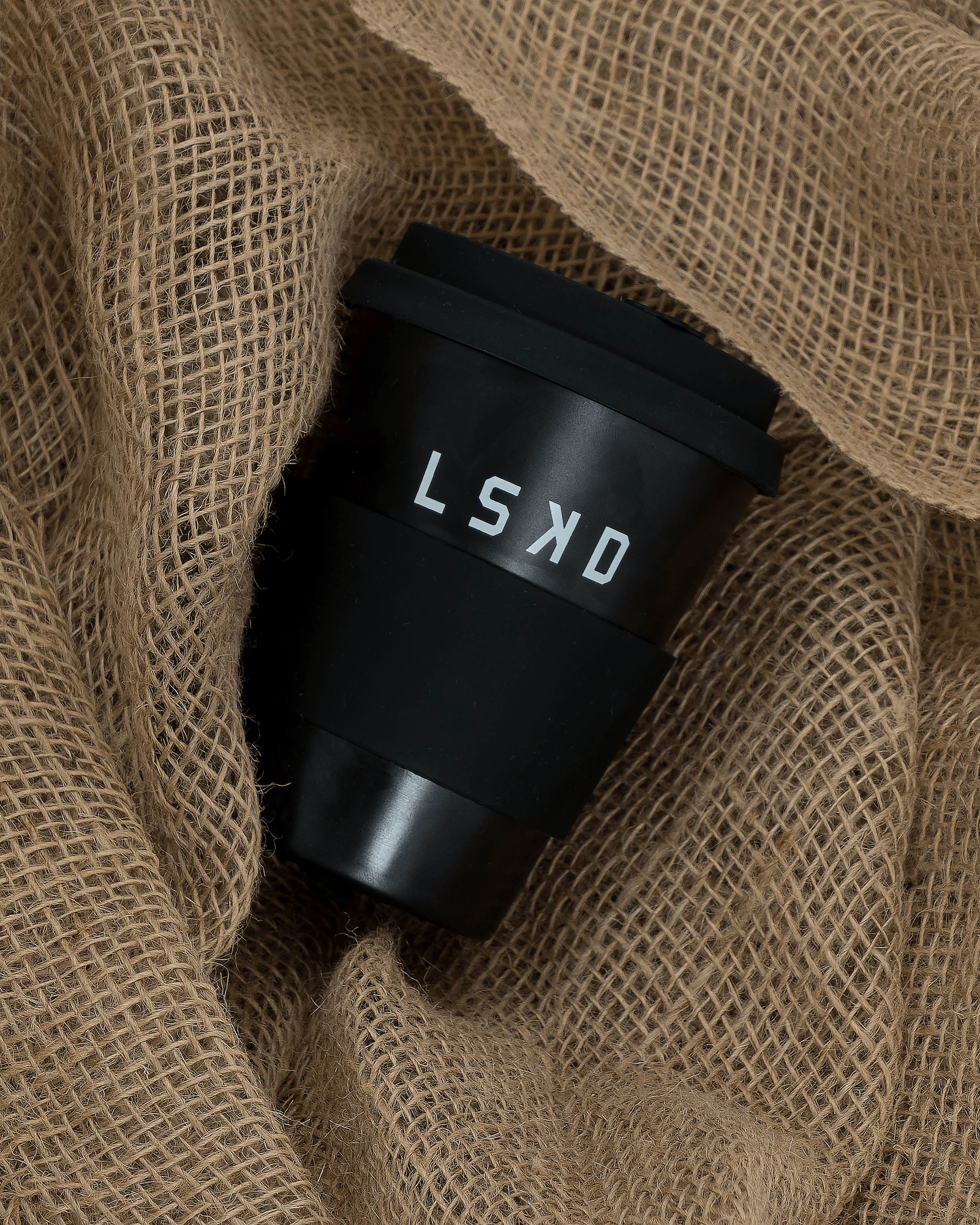 Model wearing Hot Shot Reusable Coffee Cup - Black