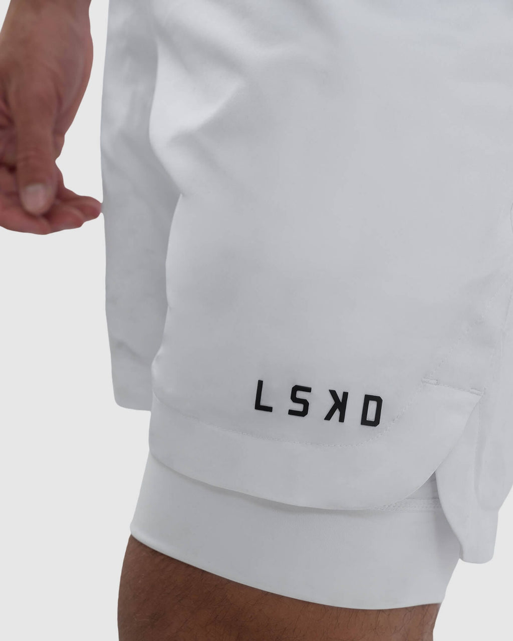 Model wearing Power 7" Performance Liner Short - White