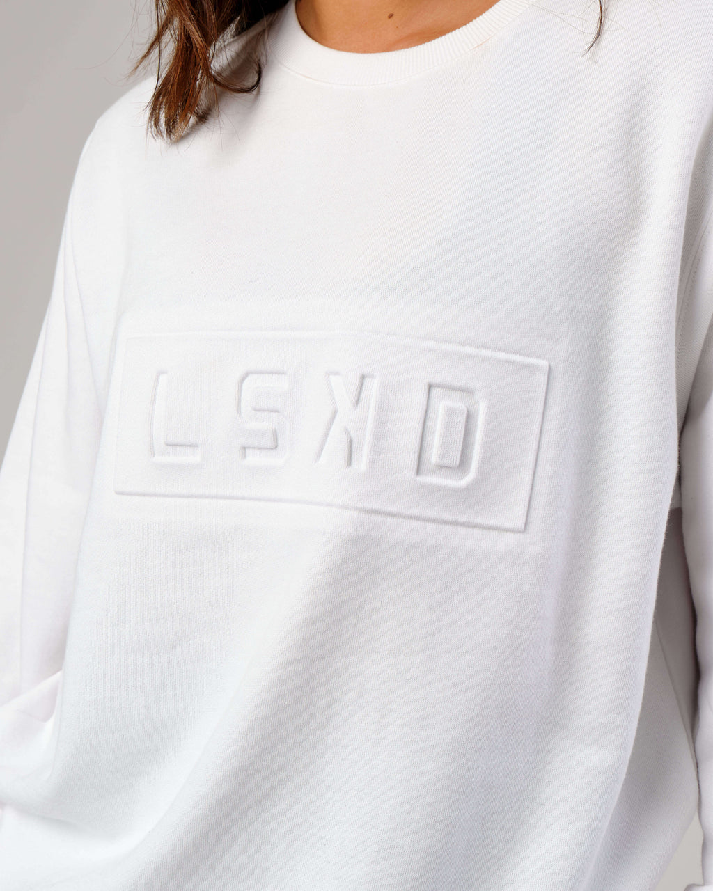 Model wearing Unisex Imprint Sweater - White