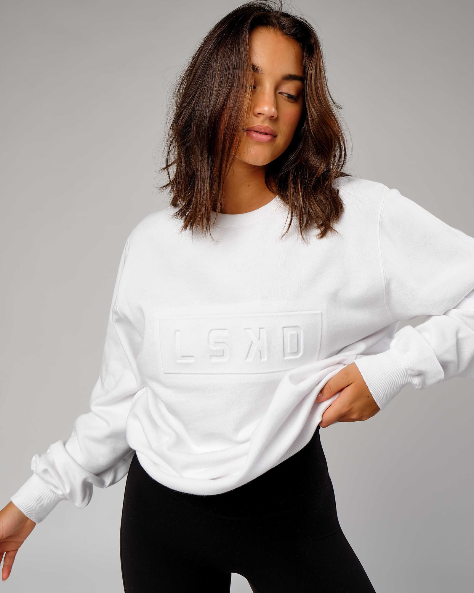 Model wearing Unisex Imprint Sweater - White