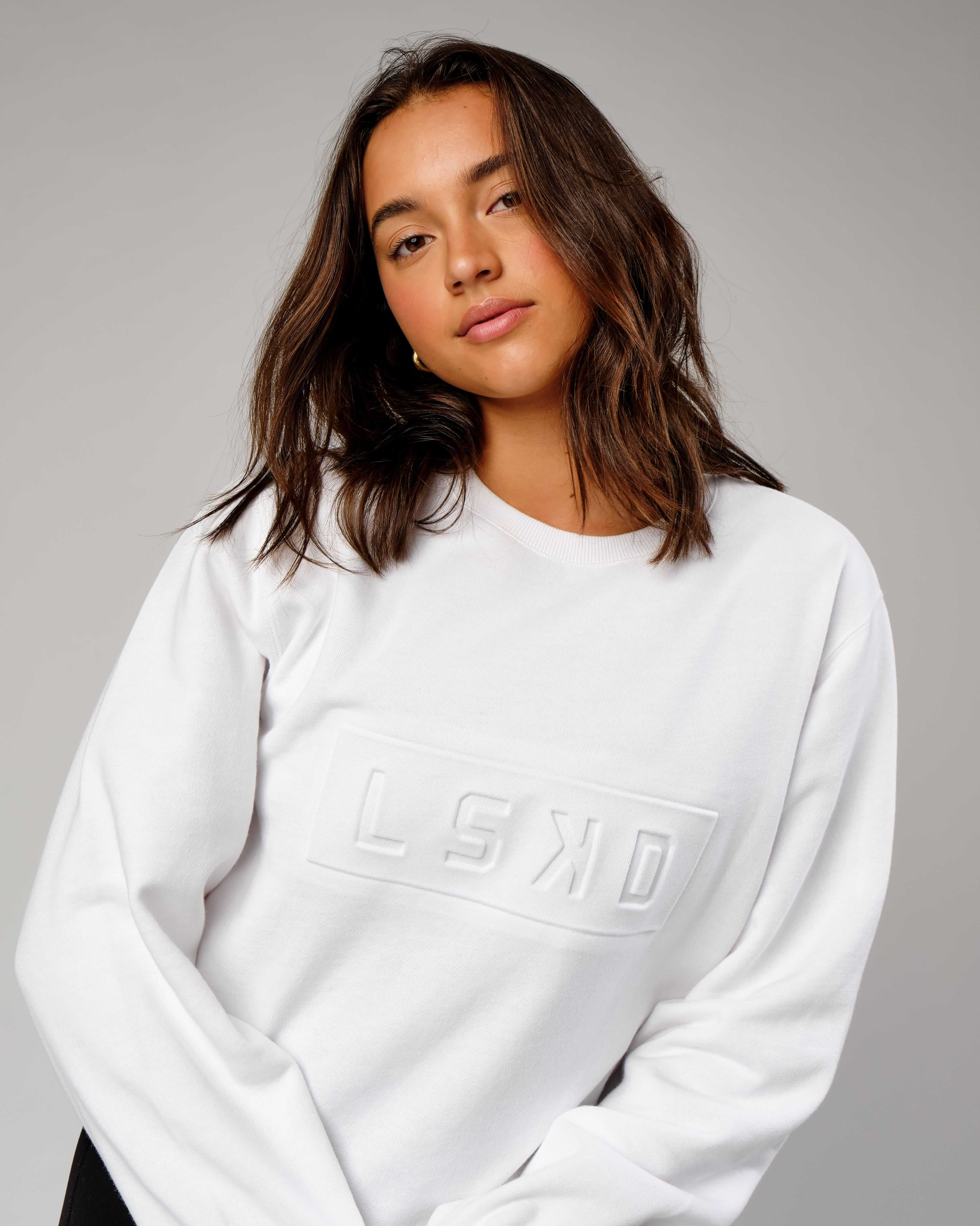 Model wearing Unisex Imprint Sweater - White