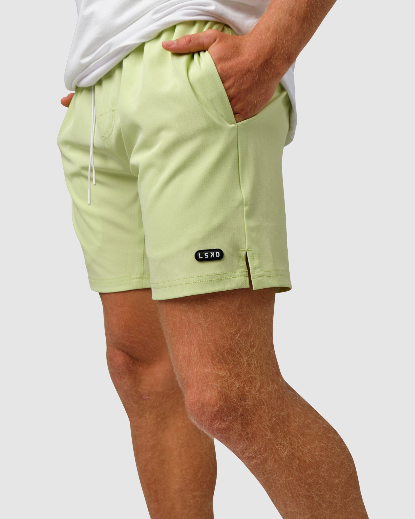 Model wearing Capsule 7" Performance Short - Pastel Lime
