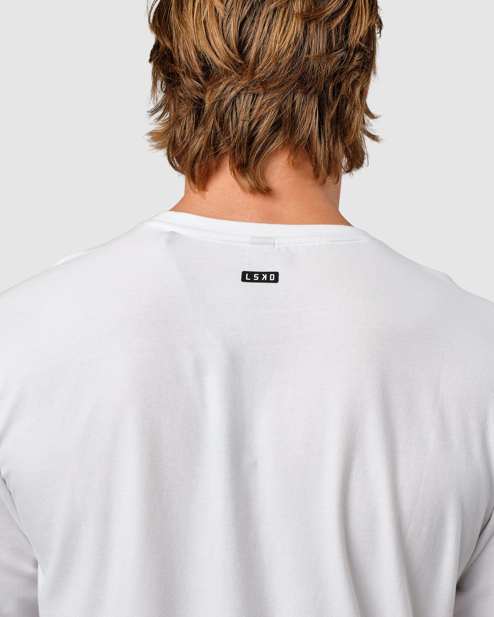 Model wearing Competitor LS Tee - White