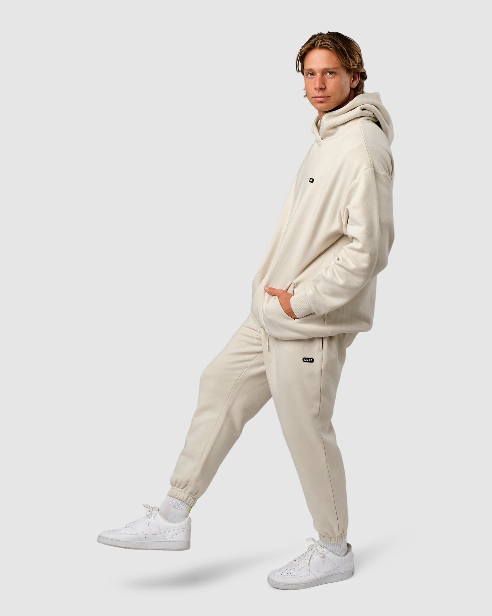 Model wearing Capsule Track Pant - Bone