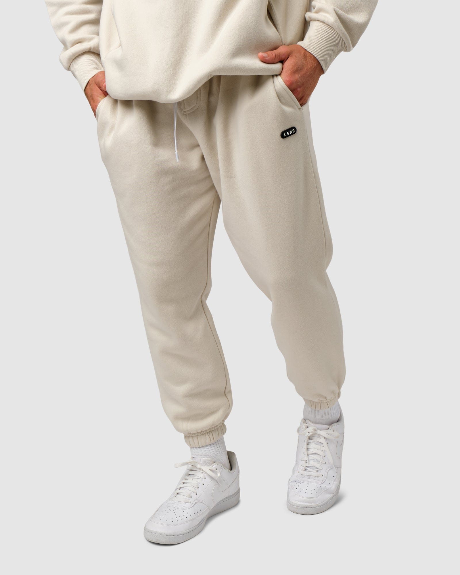 Model wearing Capsule Track Pant - Bone