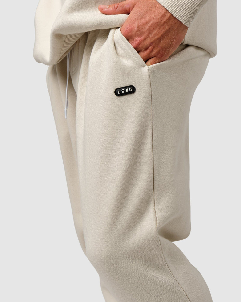 Model wearing Capsule Track Pant - Bone