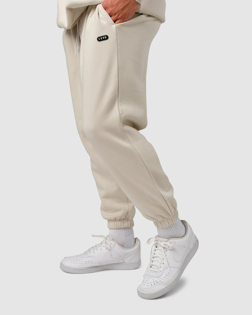 Model wearing Capsule Track Pant - Bone