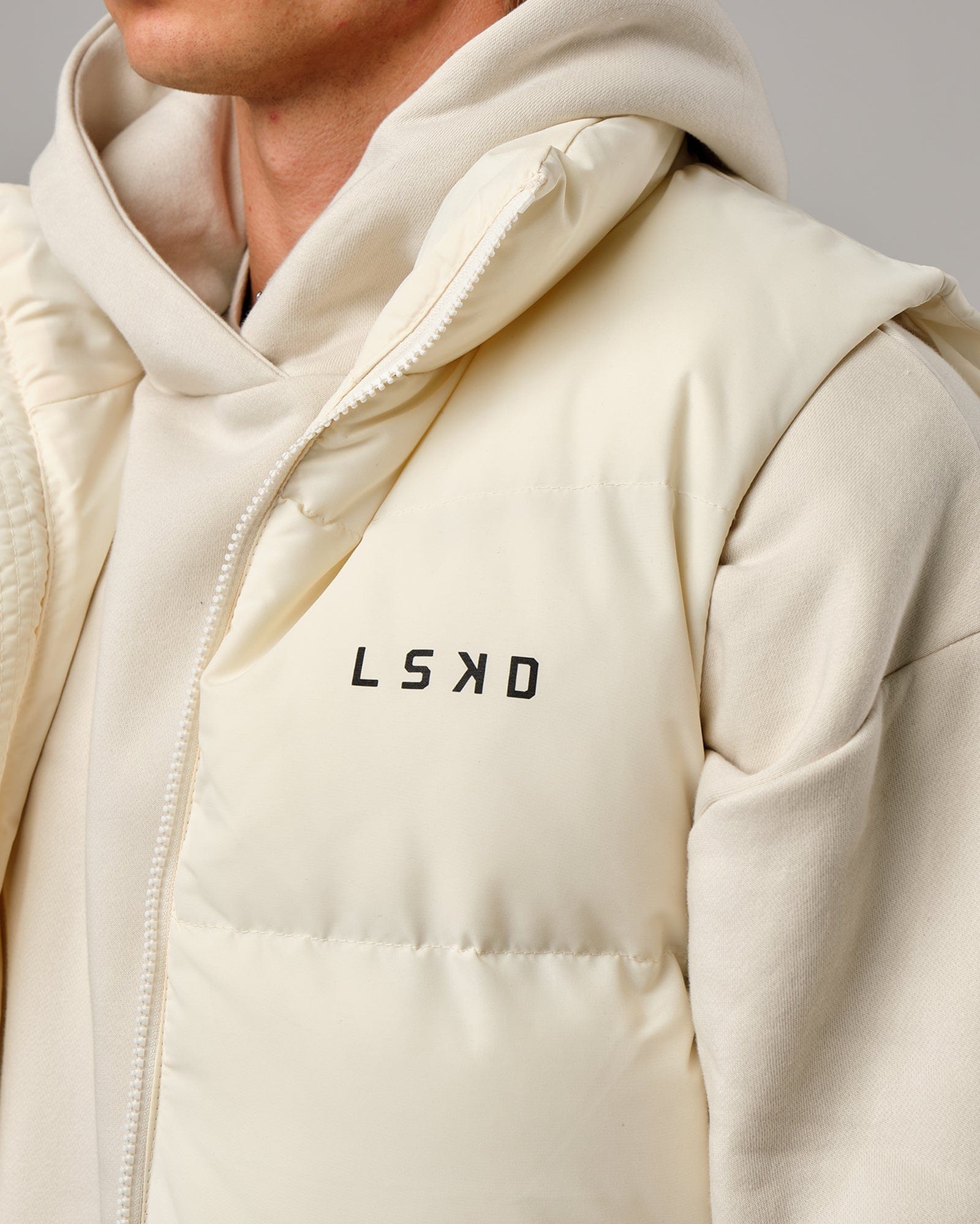 Model wearing Essential Puffer Vest - Cream