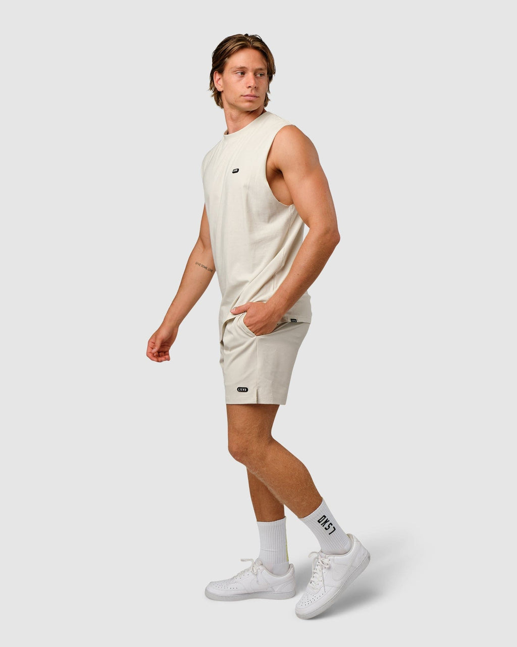 Model wearing Capsule 7" Performance Short - Bone