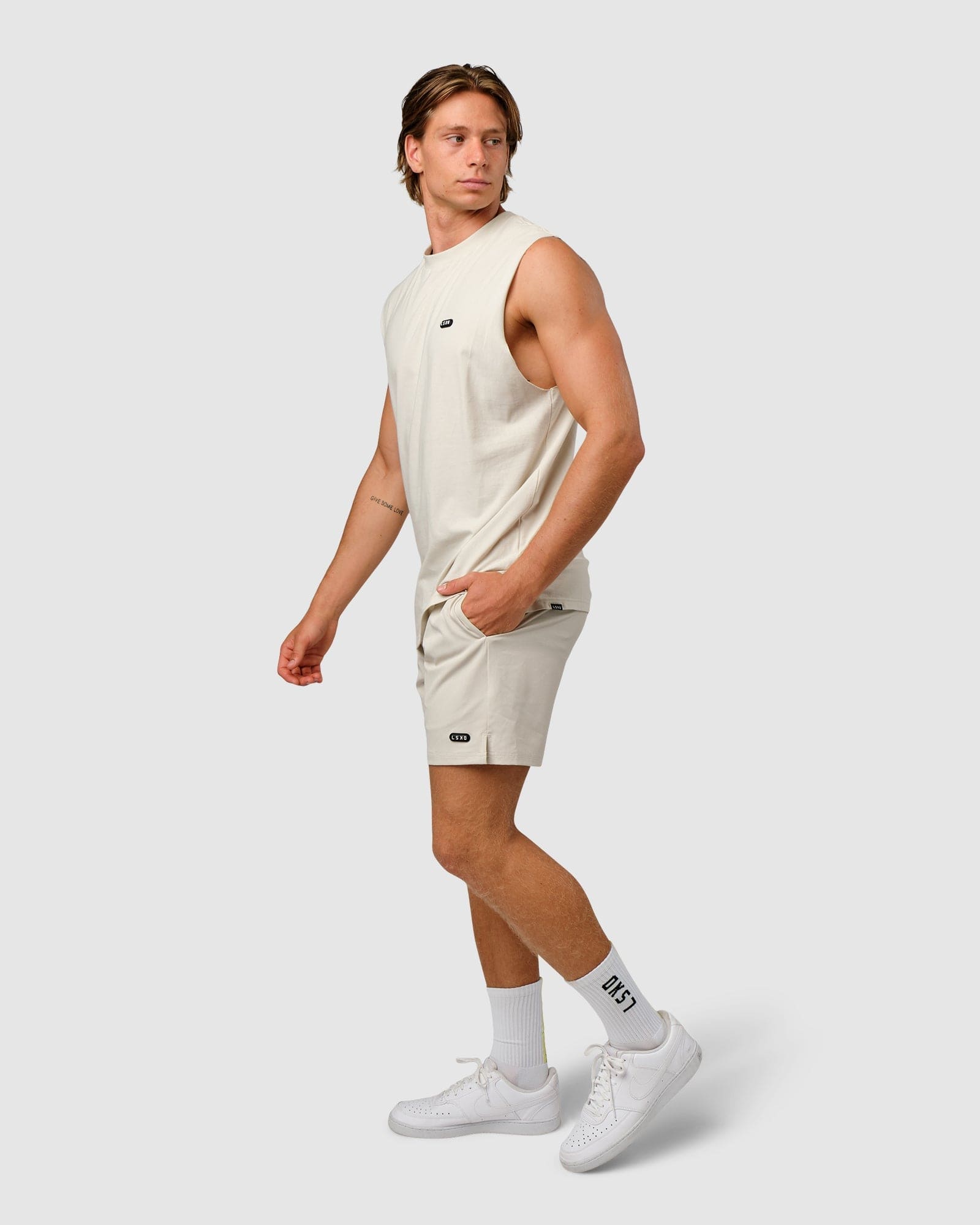 Model wearing Capsule 7" Performance Short - Bone