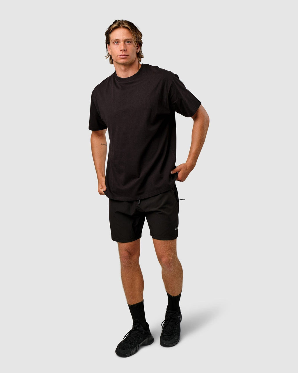 Model wearing OGTC Tee Oversize - Black