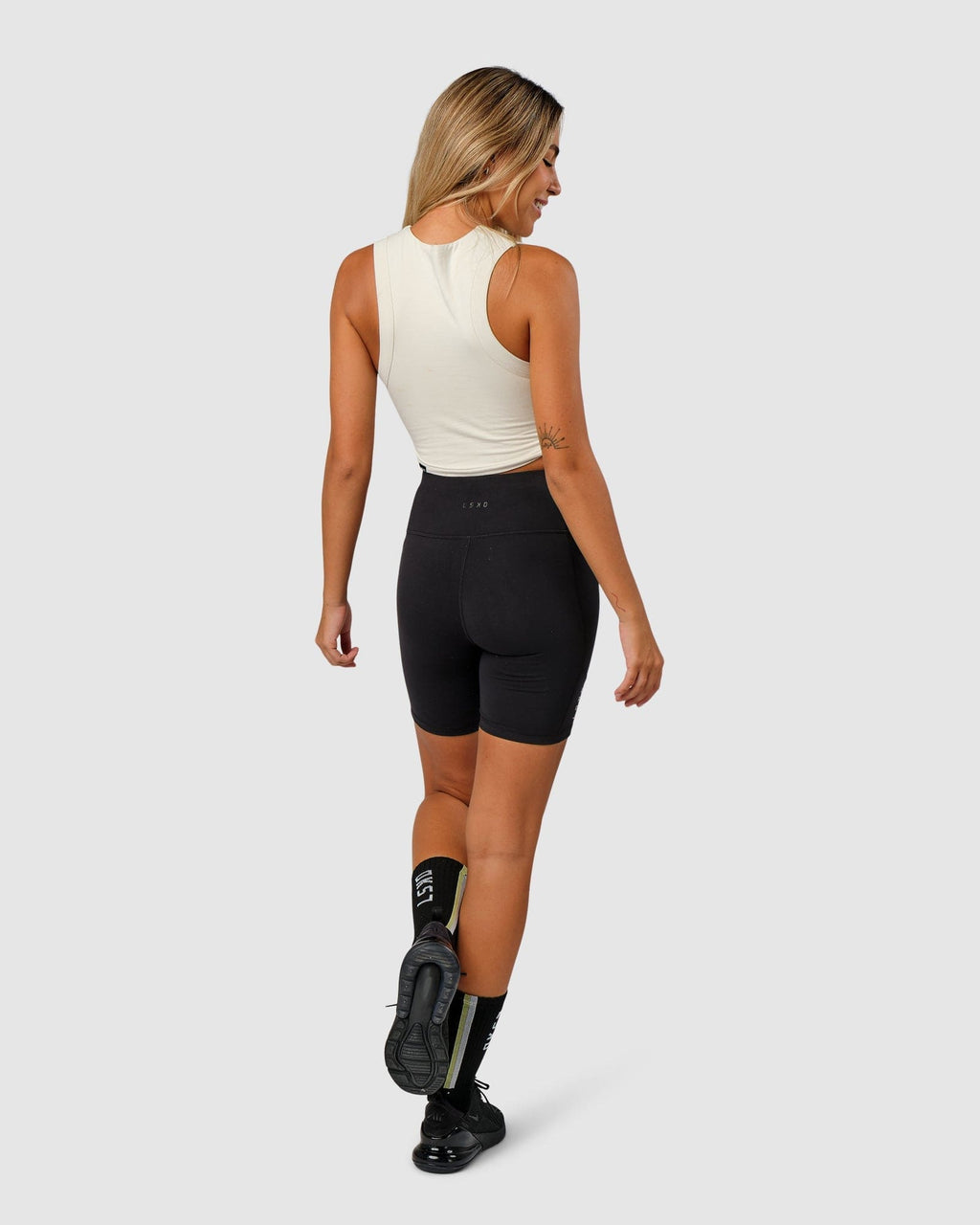 Model wearing Run Tank - Bone