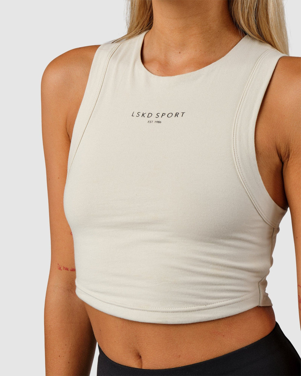 Model wearing Run Tank - Bone