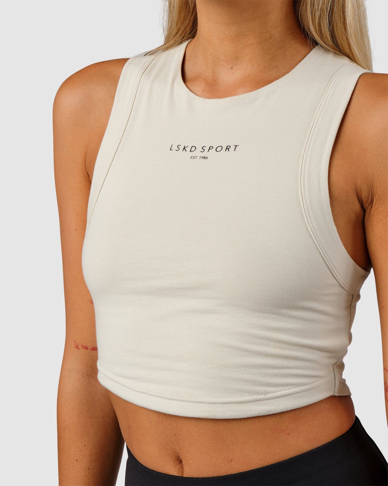 Model wearing Run Tank - Bone