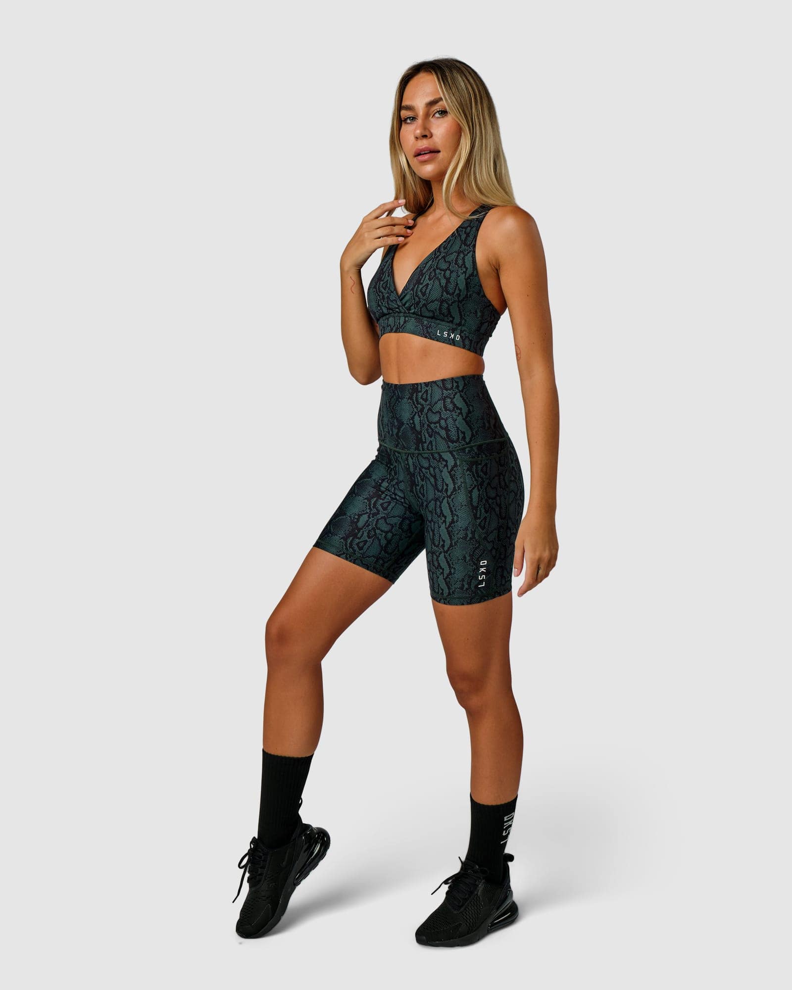 Model wearing Flux Mid Short Tight Slimline Elastic Waistband - Forest Snakeskin