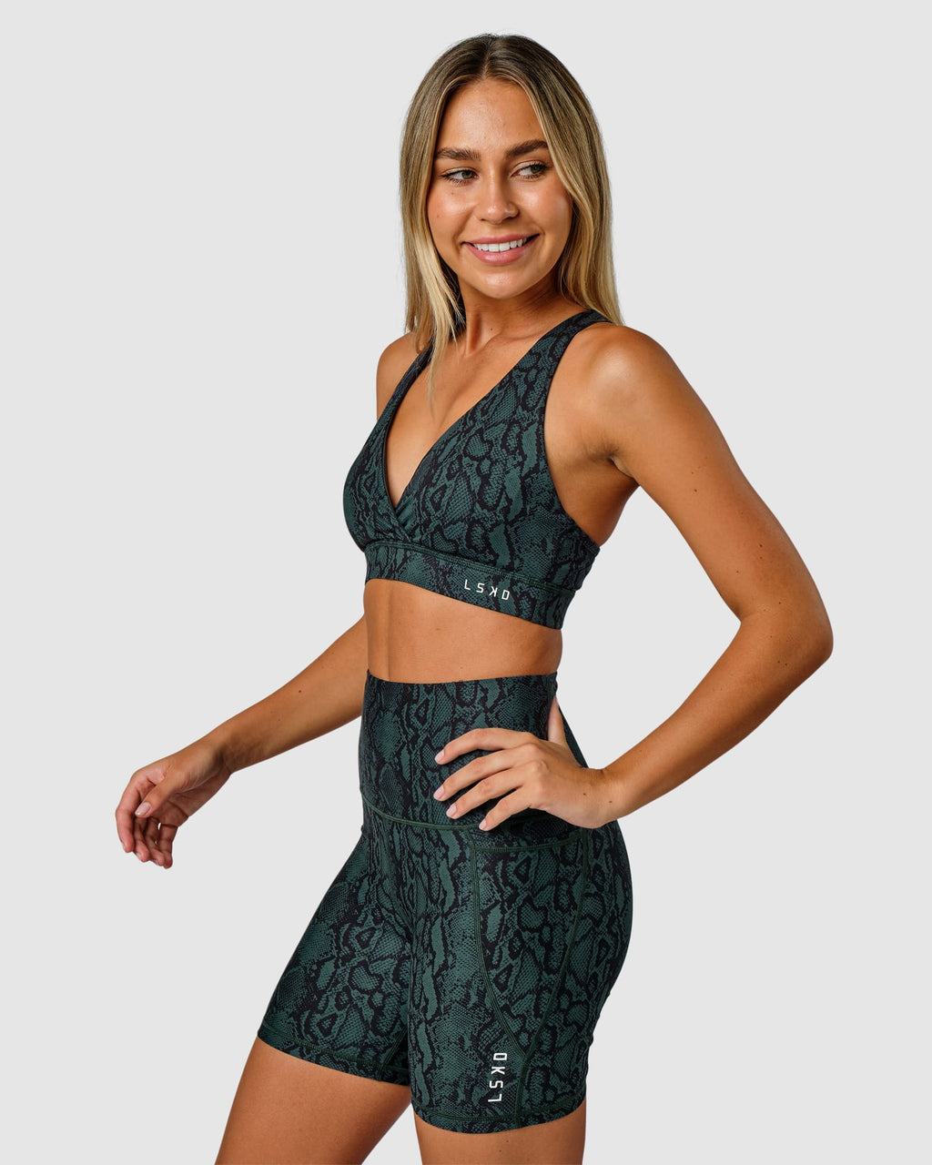 Model wearing Flux Mid Short Tight Slimline Elastic Waistband - Forest Snakeskin