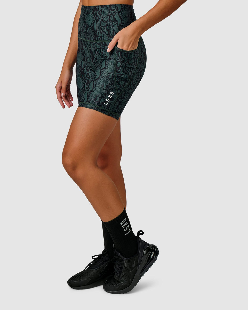 Model wearing Flux Mid Short Tight Slimline Elastic Waistband - Forest Snakeskin