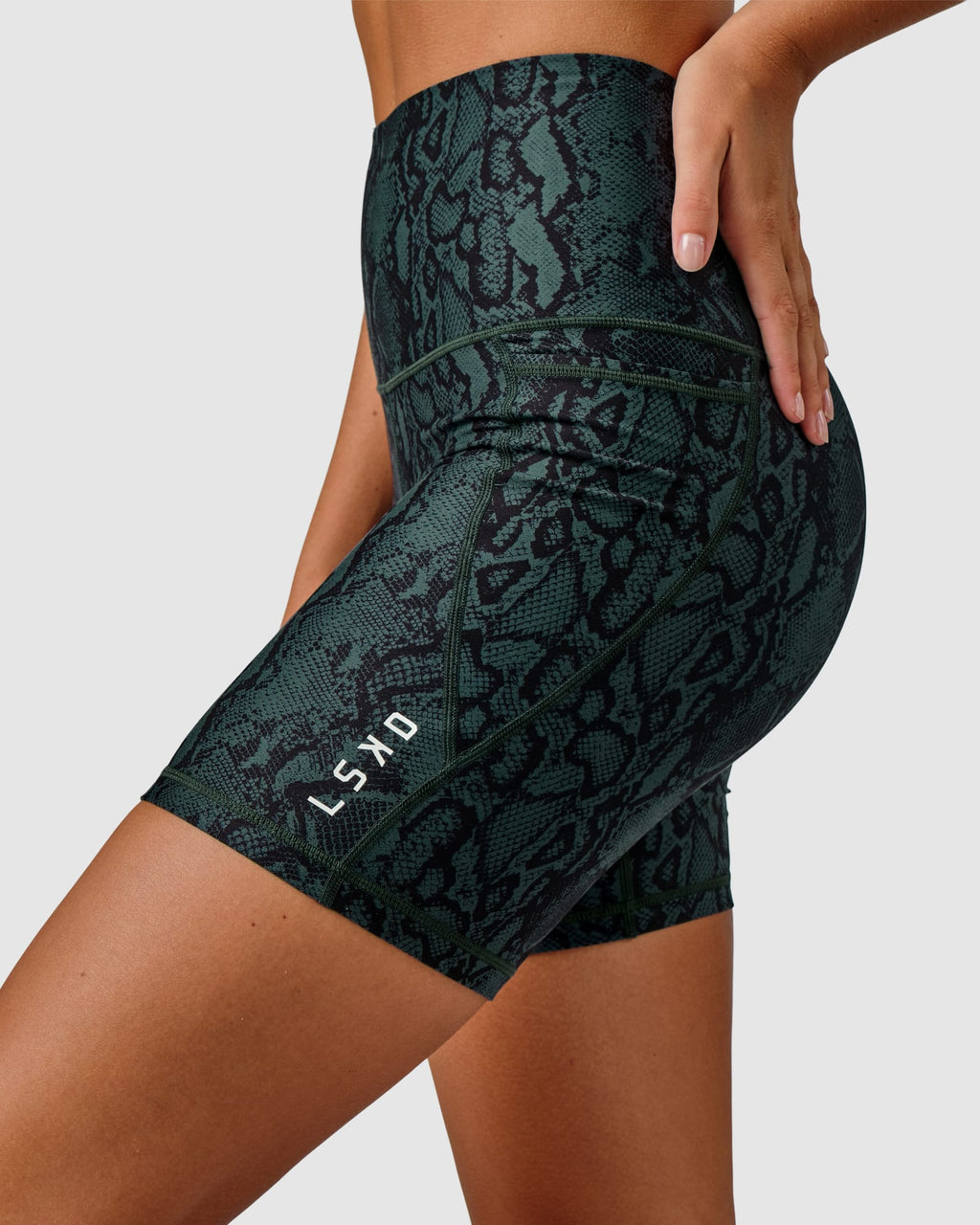 Model wearing Flux Mid Short Tight Slimline Elastic Waistband - Forest Snakeskin
