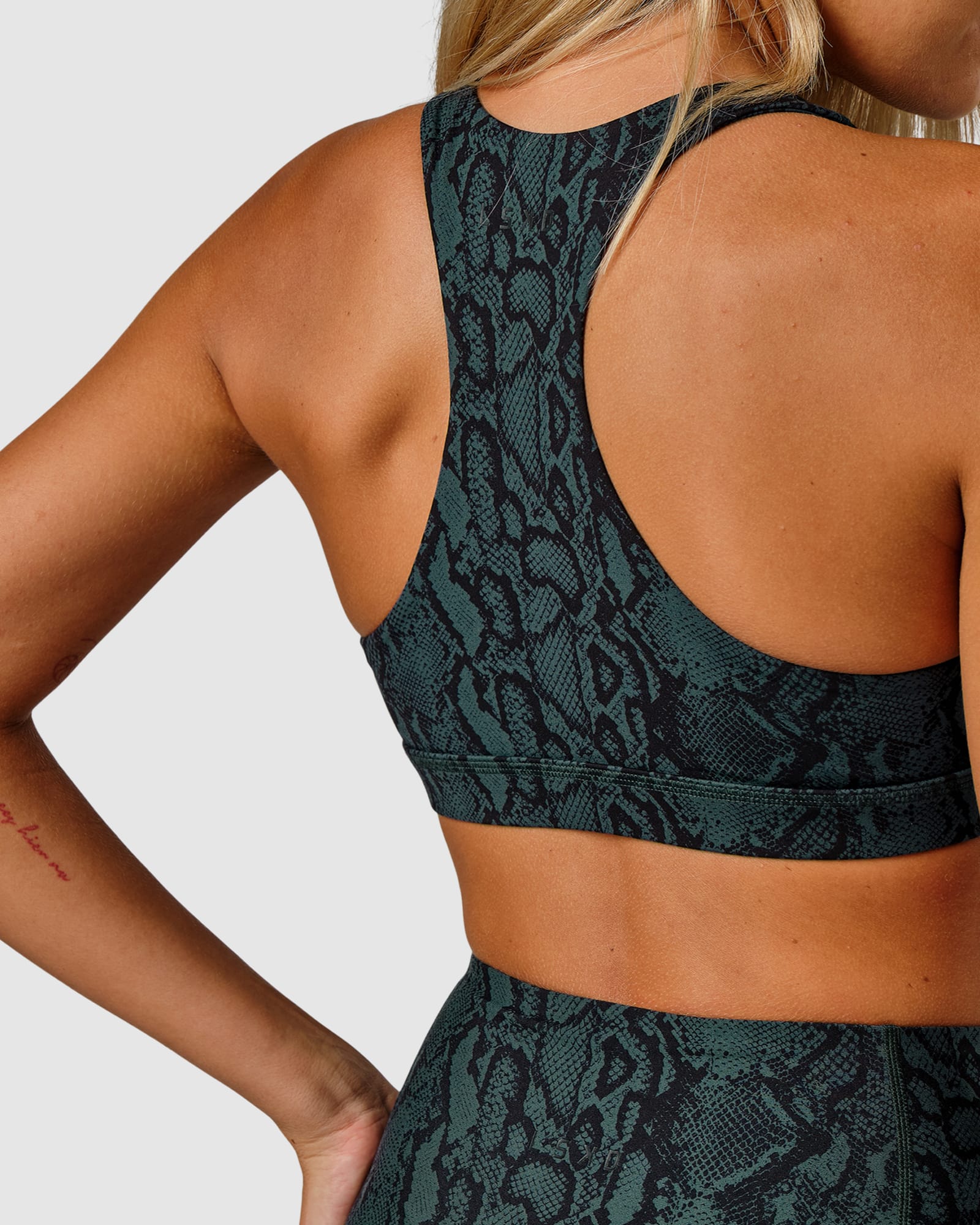 Model wearing Base Sports Bra - Forest Snakeskin
