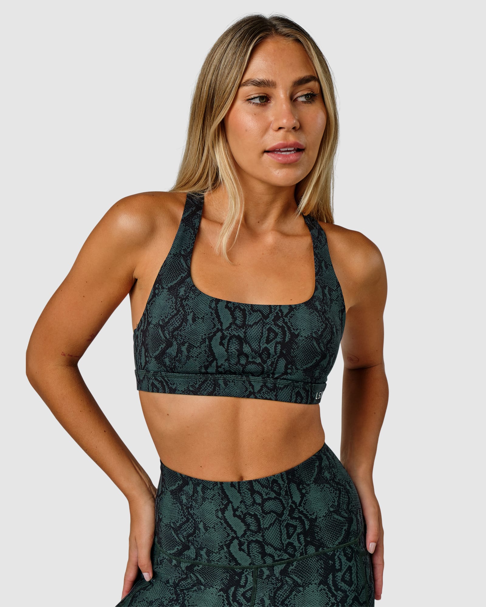 Model wearing Base Sports Bra - Forest Snakeskin