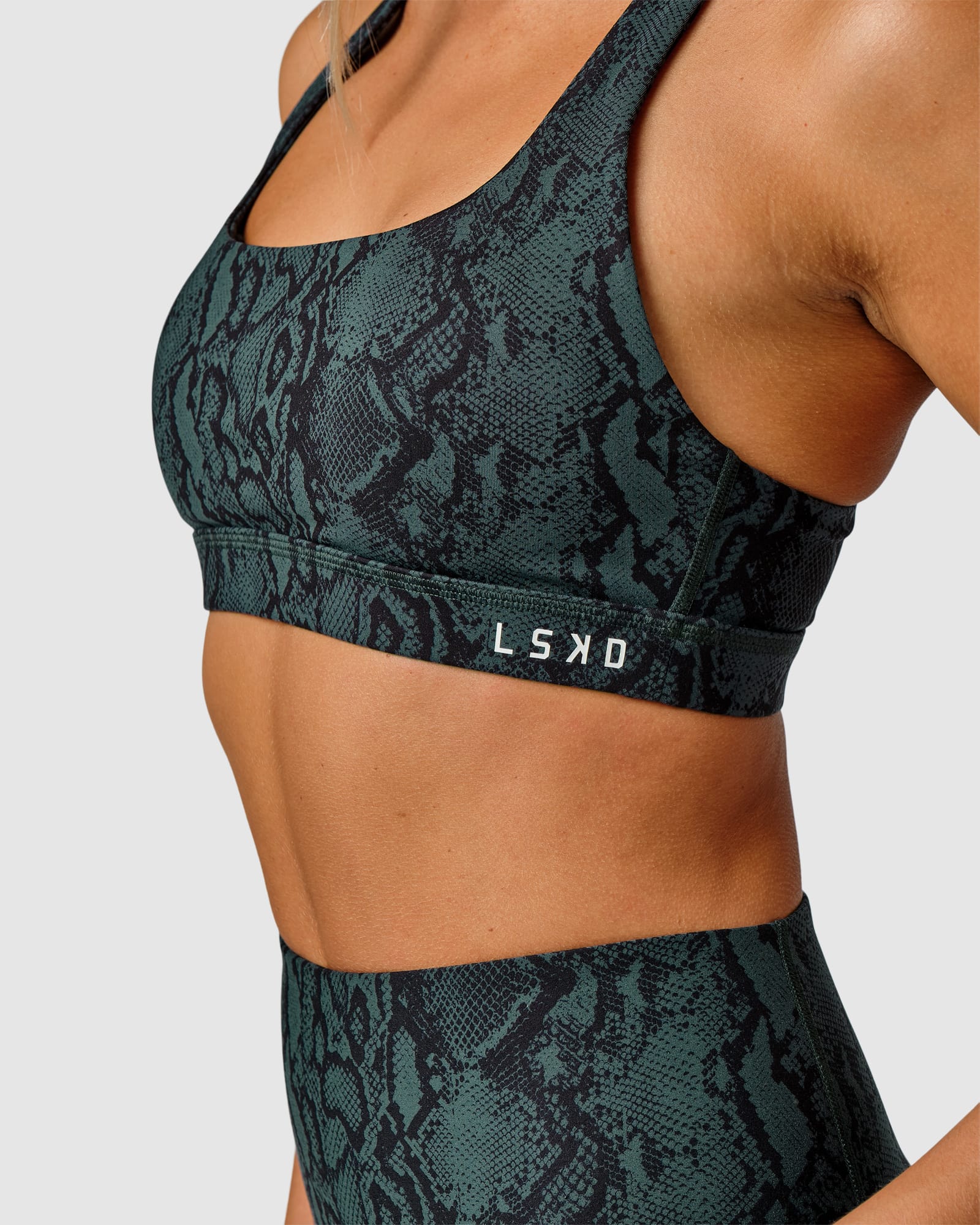 Model wearing Base Sports Bra - Forest Snakeskin