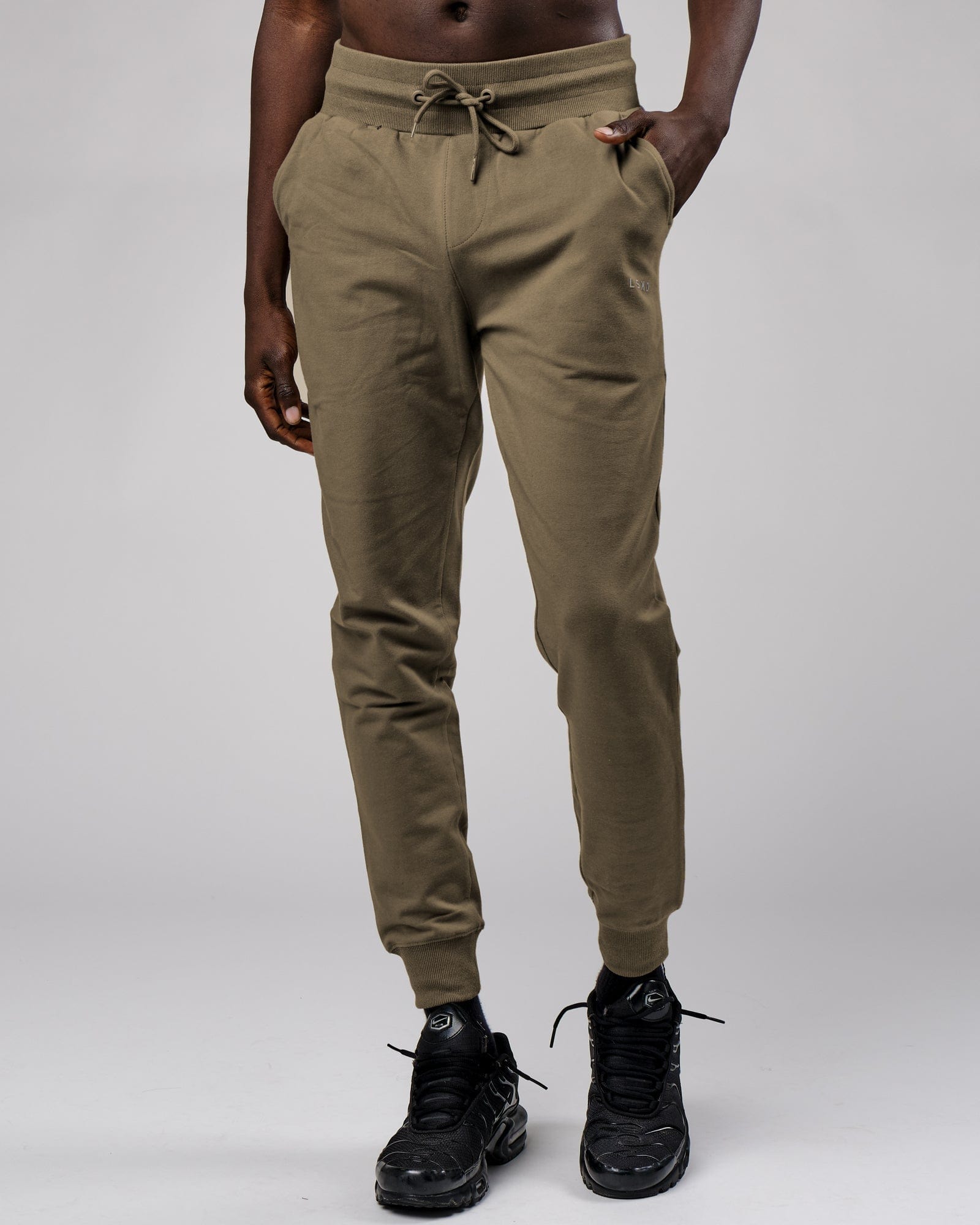 Model wearing Base Track Pant - Walnut Grey