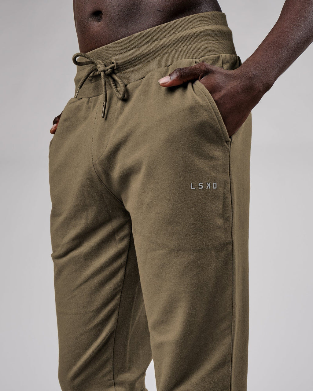Model wearing Base Track Pant - Walnut Grey