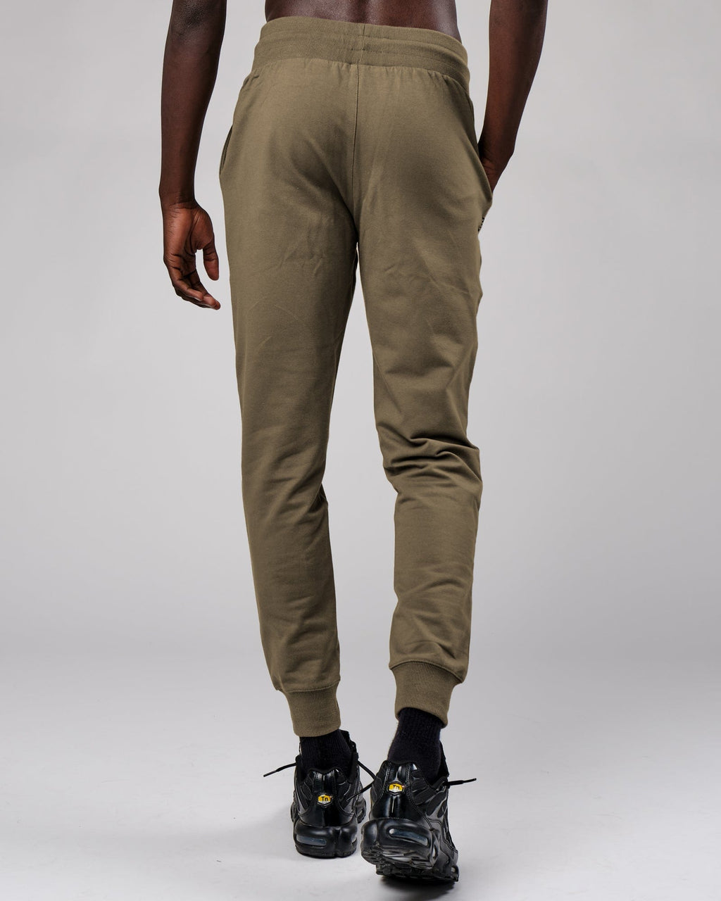 Model wearing Base Track Pant - Walnut Grey