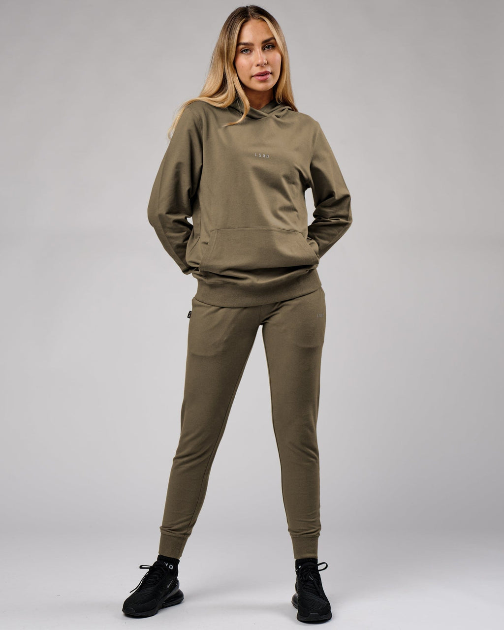 Model wearing Unisex Base Track Pant - Walnut Grey