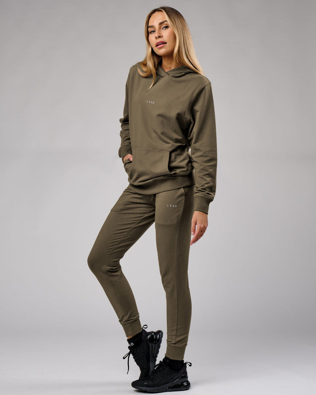 Model wearing Unisex Base Hoodie - Walnut Grey