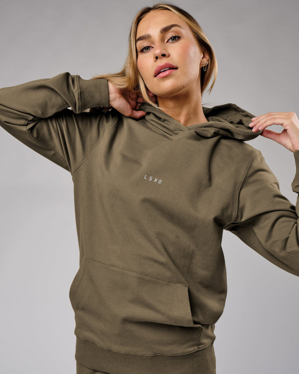 Model wearing Unisex Base Hoodie - Walnut Grey