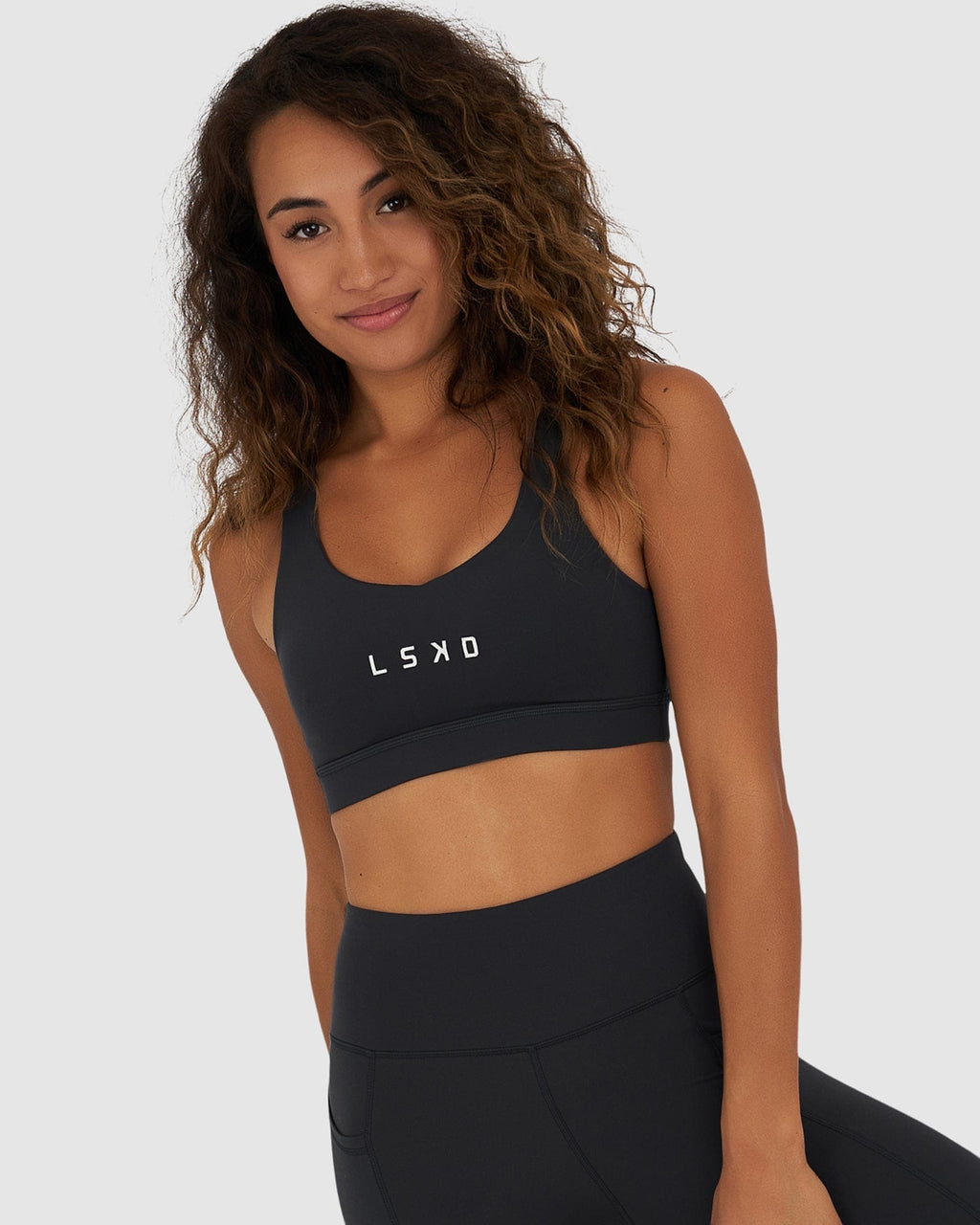 Model wearing Rep Sports Bra Small Logo - Midnight