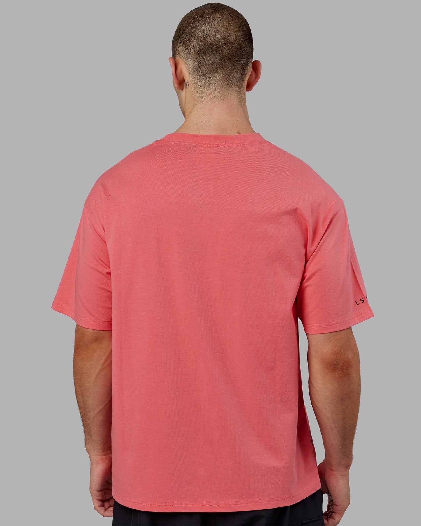 Model wearing Strive FLXCotton Tee Oversize - Sunkist Coral