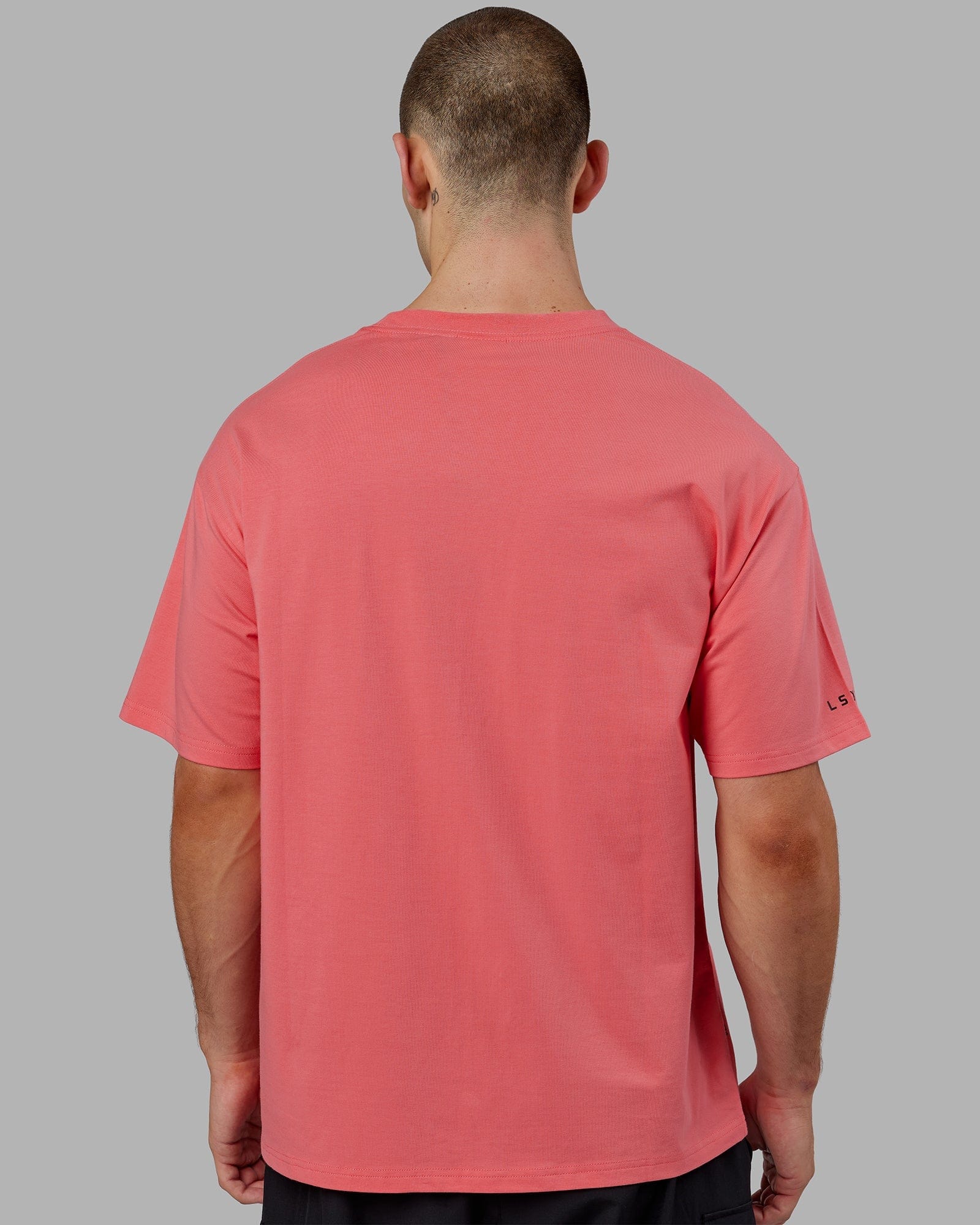 Model wearing Strive FLXCotton Tee Oversize - Sunkist Coral