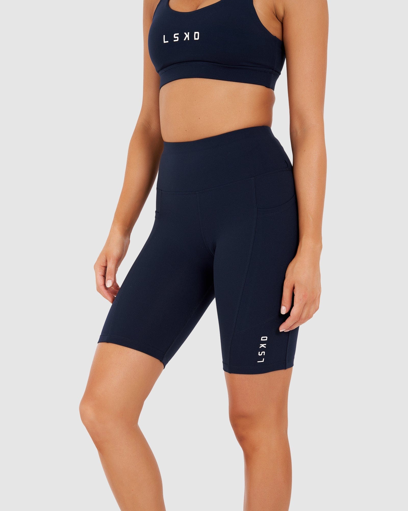 Model wearing Rep Short Tight Small Logo - Navy