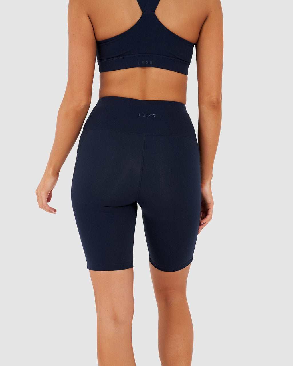 Model wearing Rep Short Tight Small Logo - Navy