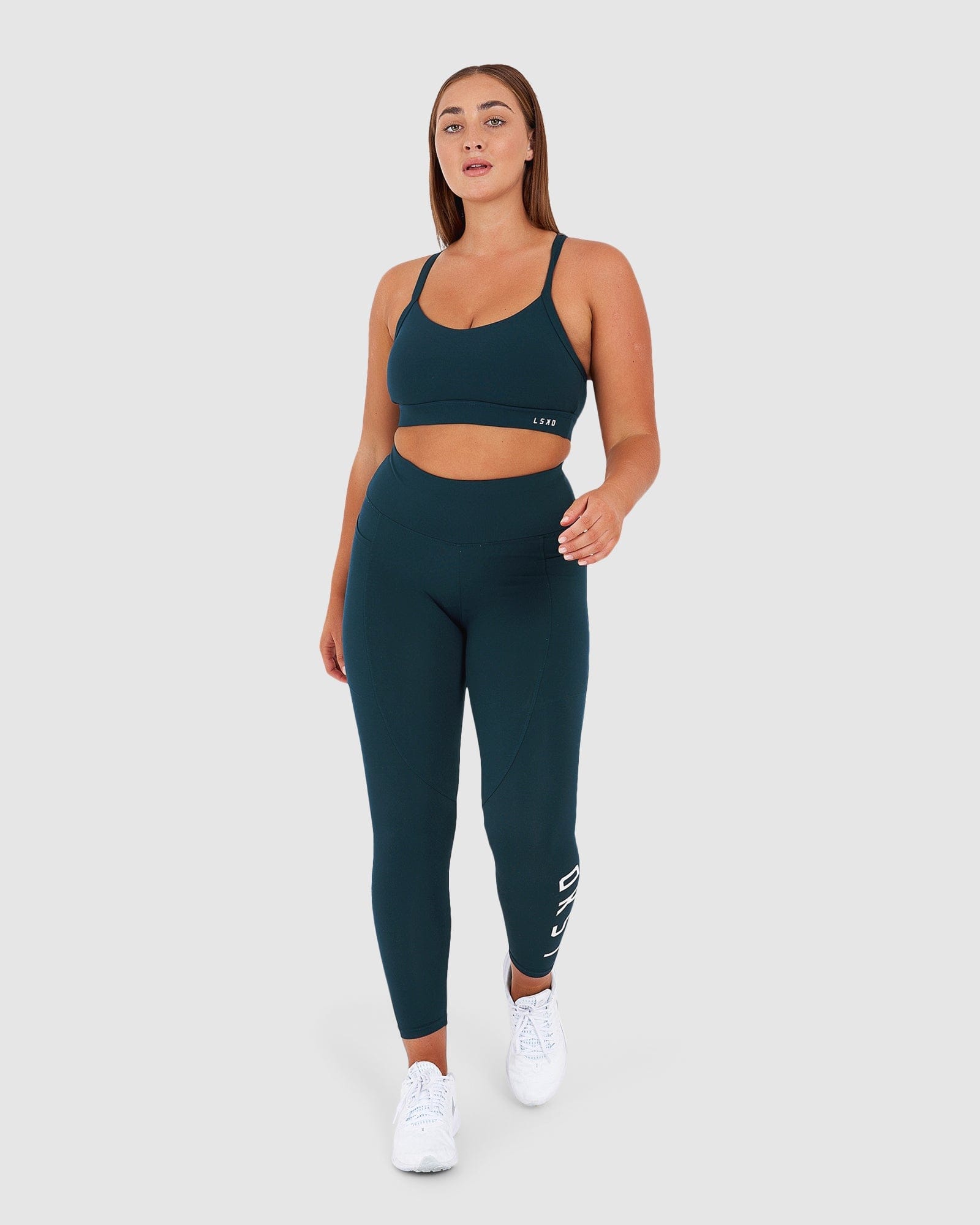 Model wearing Momentum Sports Bra - Deep Teal