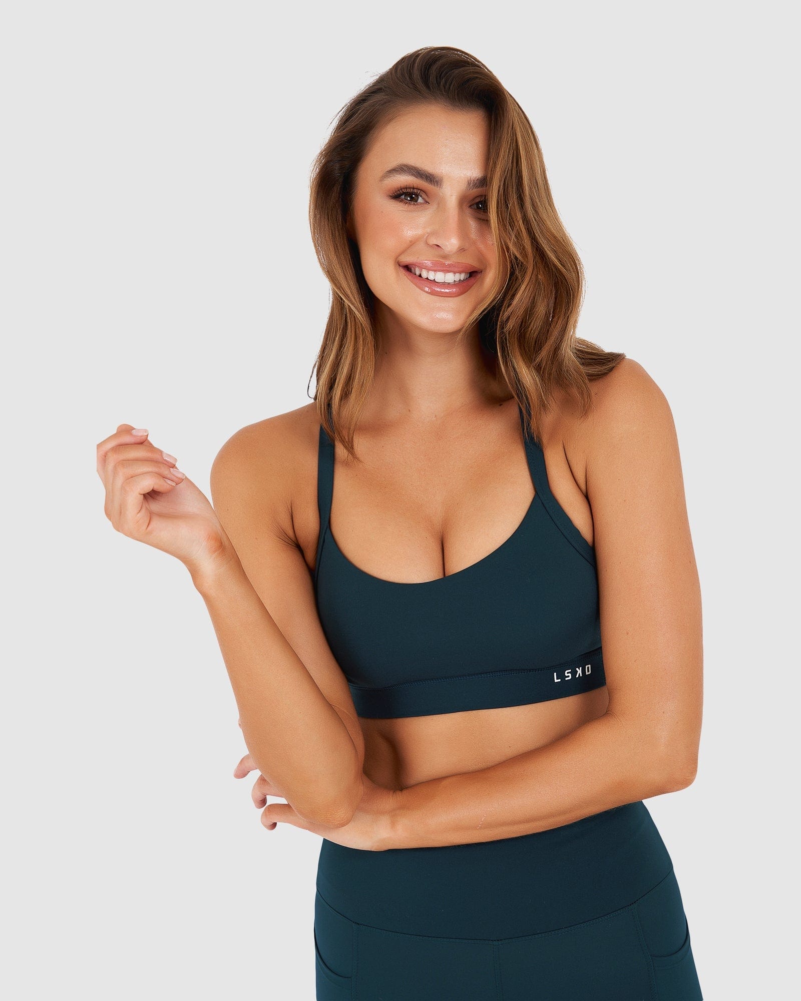 Model wearing Momentum Sports Bra - Deep Teal