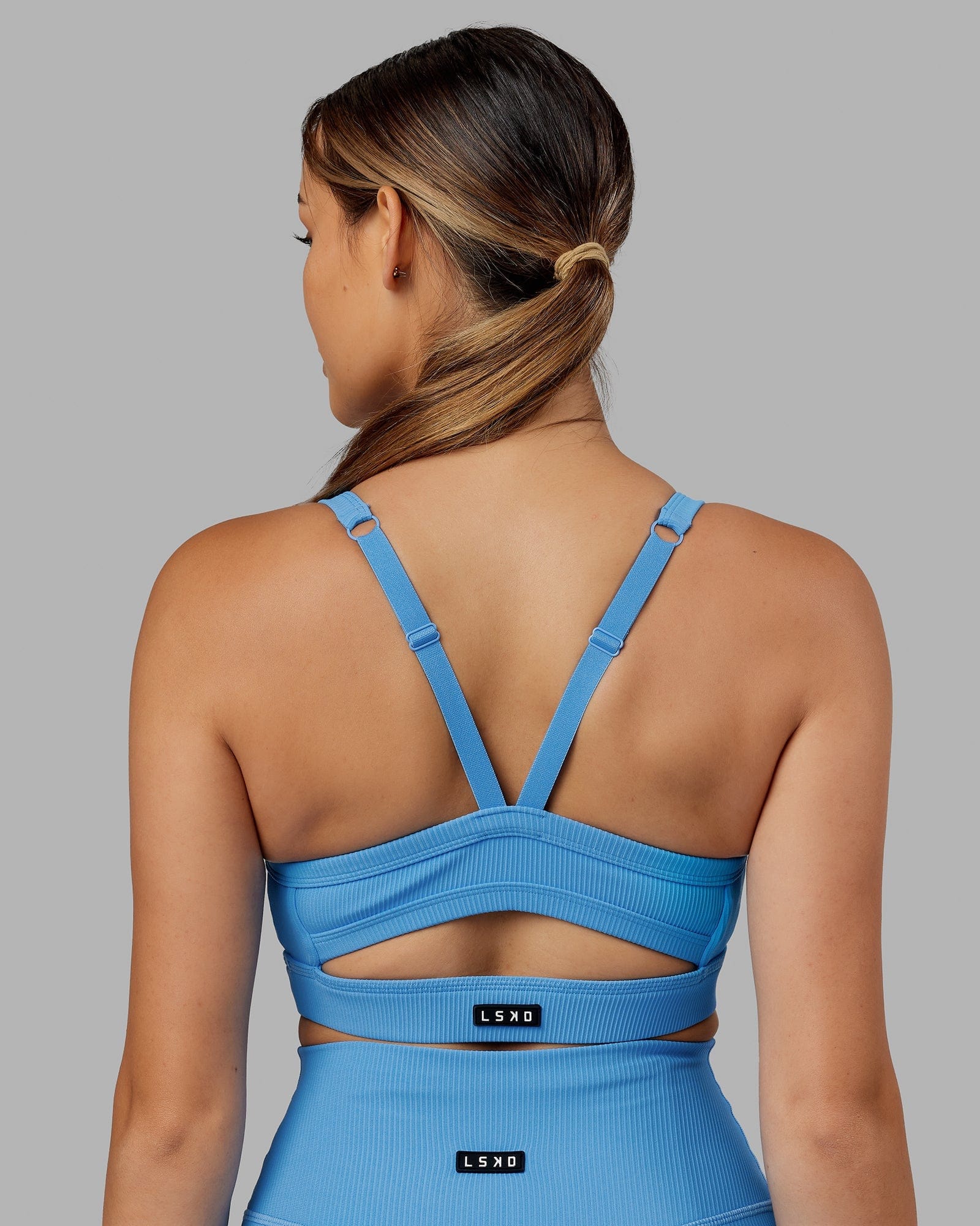 Model wearing Momentum Ribbed Sports Bra - Azure Blue