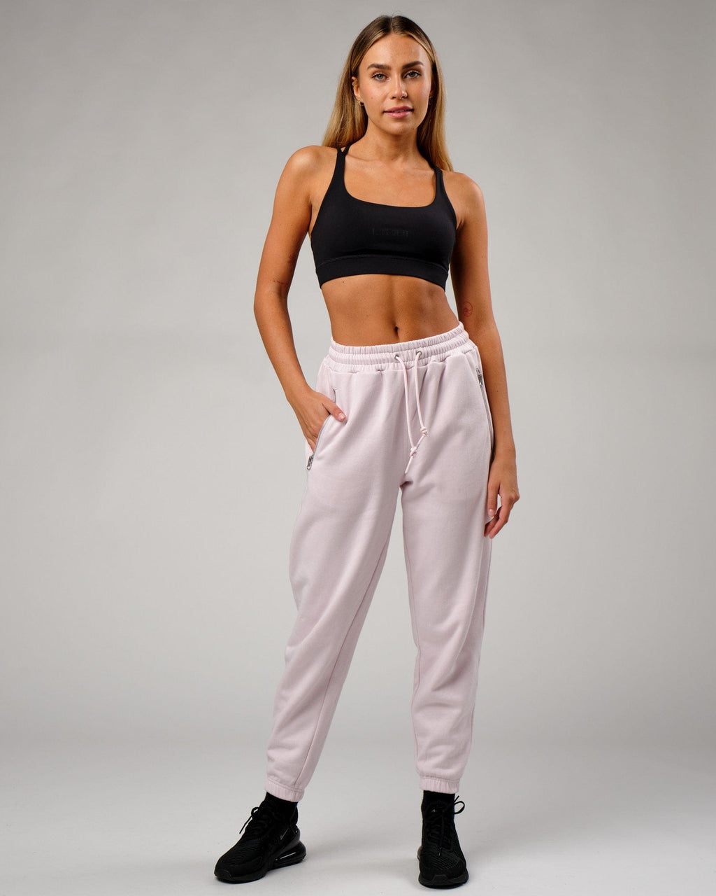 Model wearing Becca Track Pant - Orchid Ice