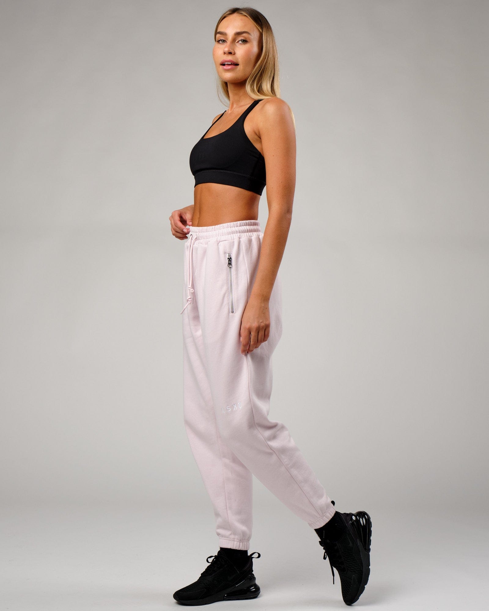Model wearing Becca Track Pant - Orchid Ice