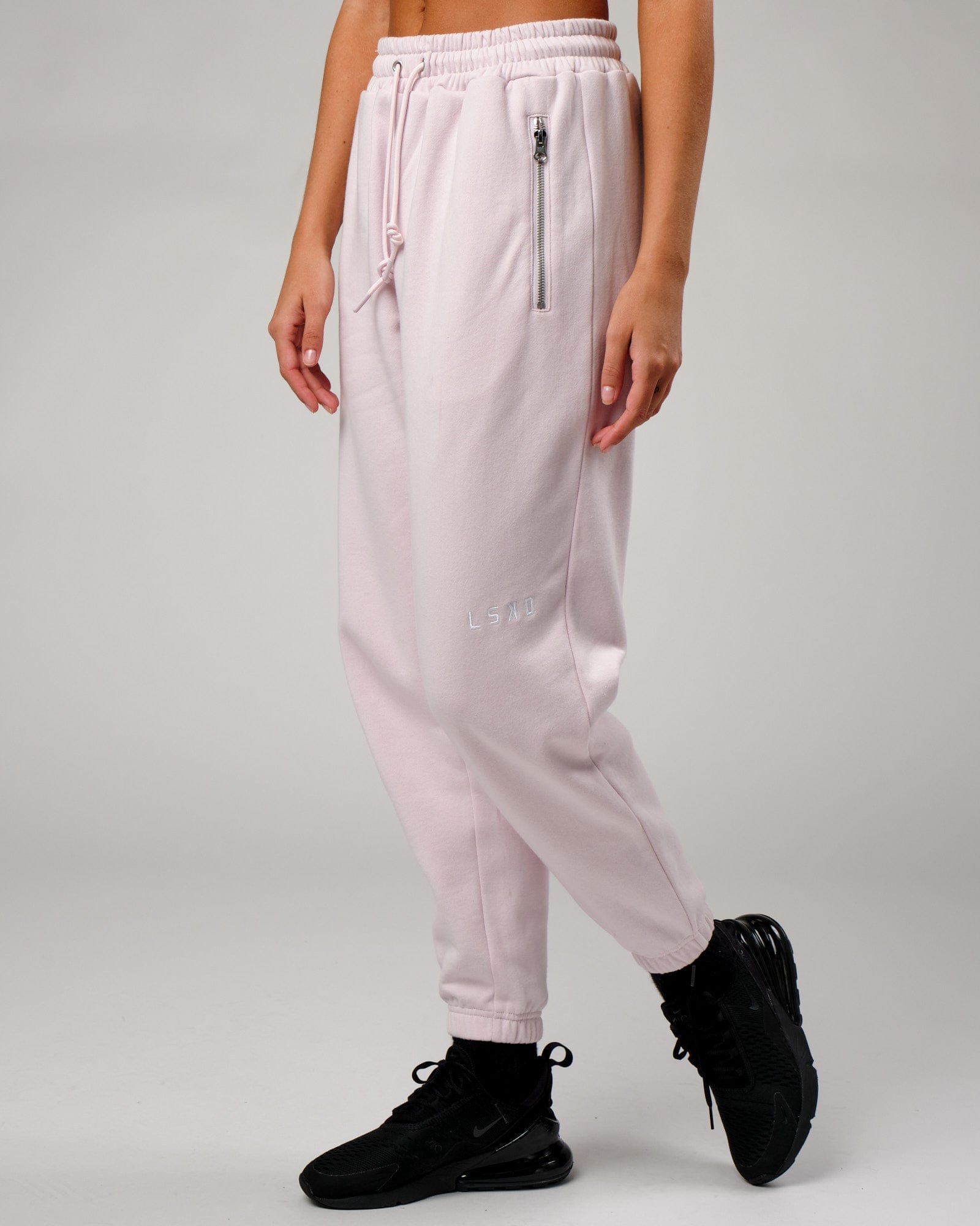 Model wearing Becca Track Pant - Orchid Ice