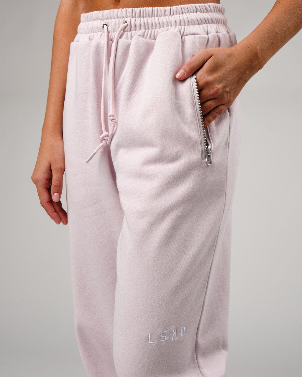 Model wearing Becca Track Pant - Orchid Ice