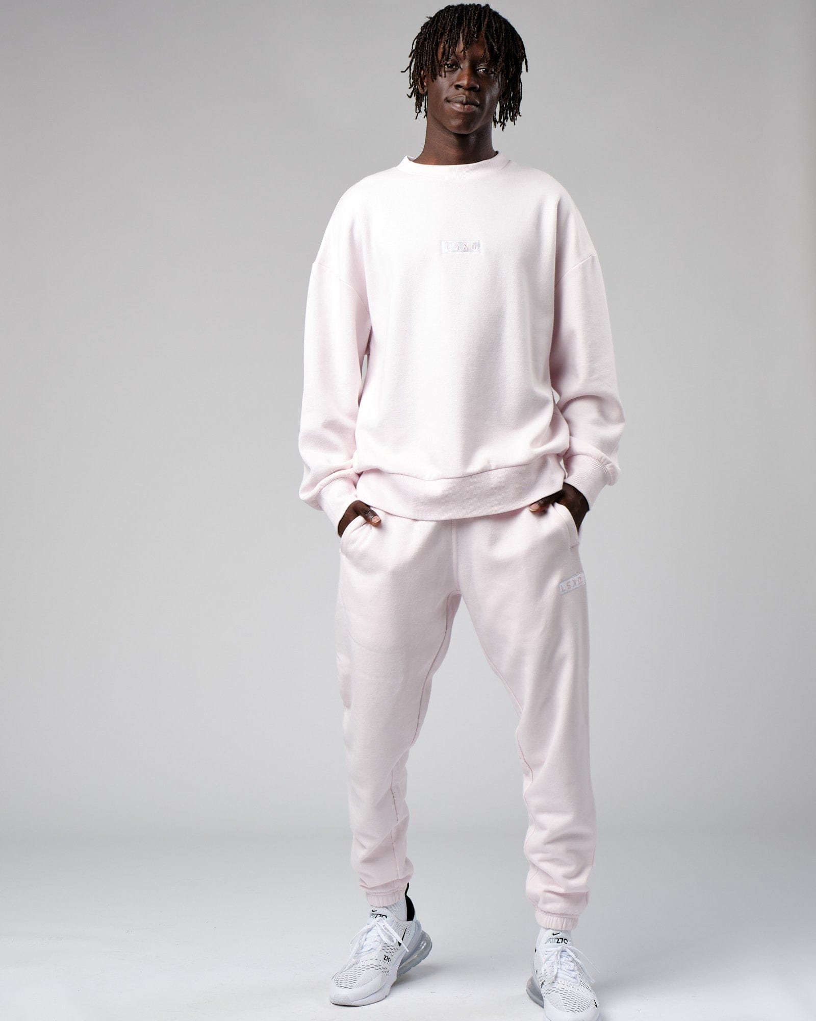 Model wearing Cornerstone Track Pant Oversize - Orchid Ice