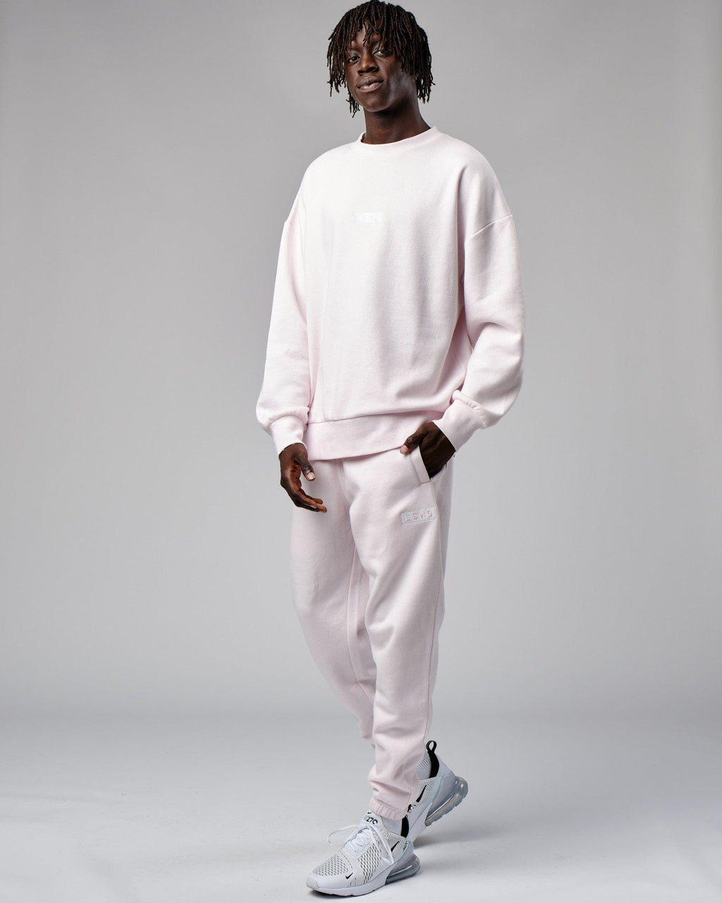 Model wearing Cornerstone Track Pant Oversize - Orchid Ice