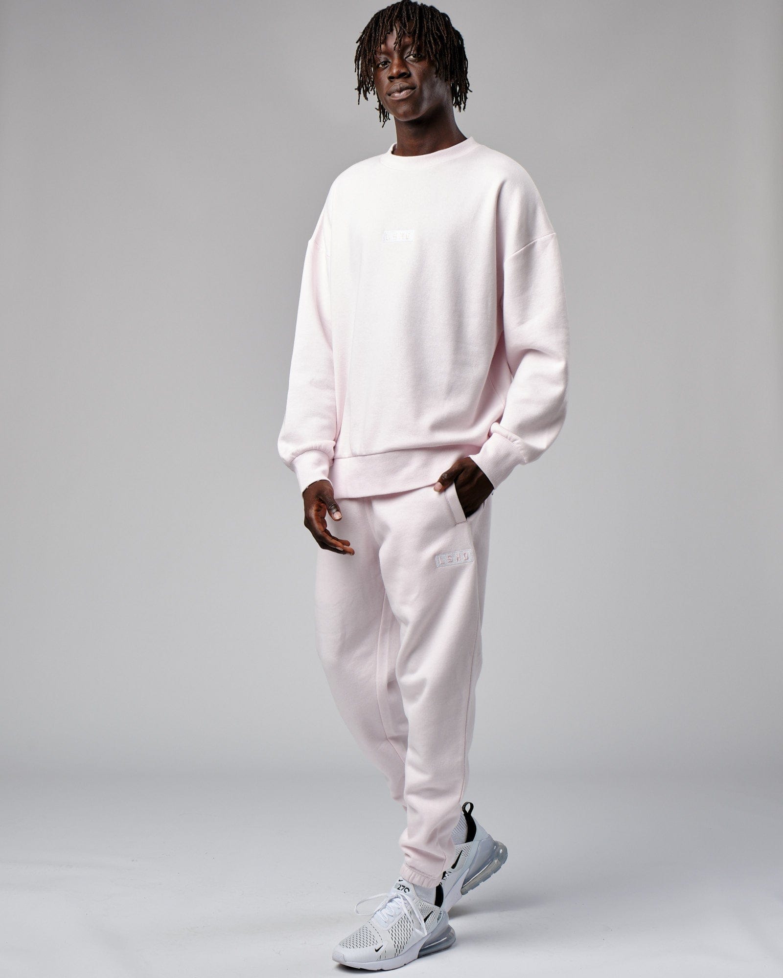 Model wearing Cornerstone Track Pant Oversize - Orchid Ice