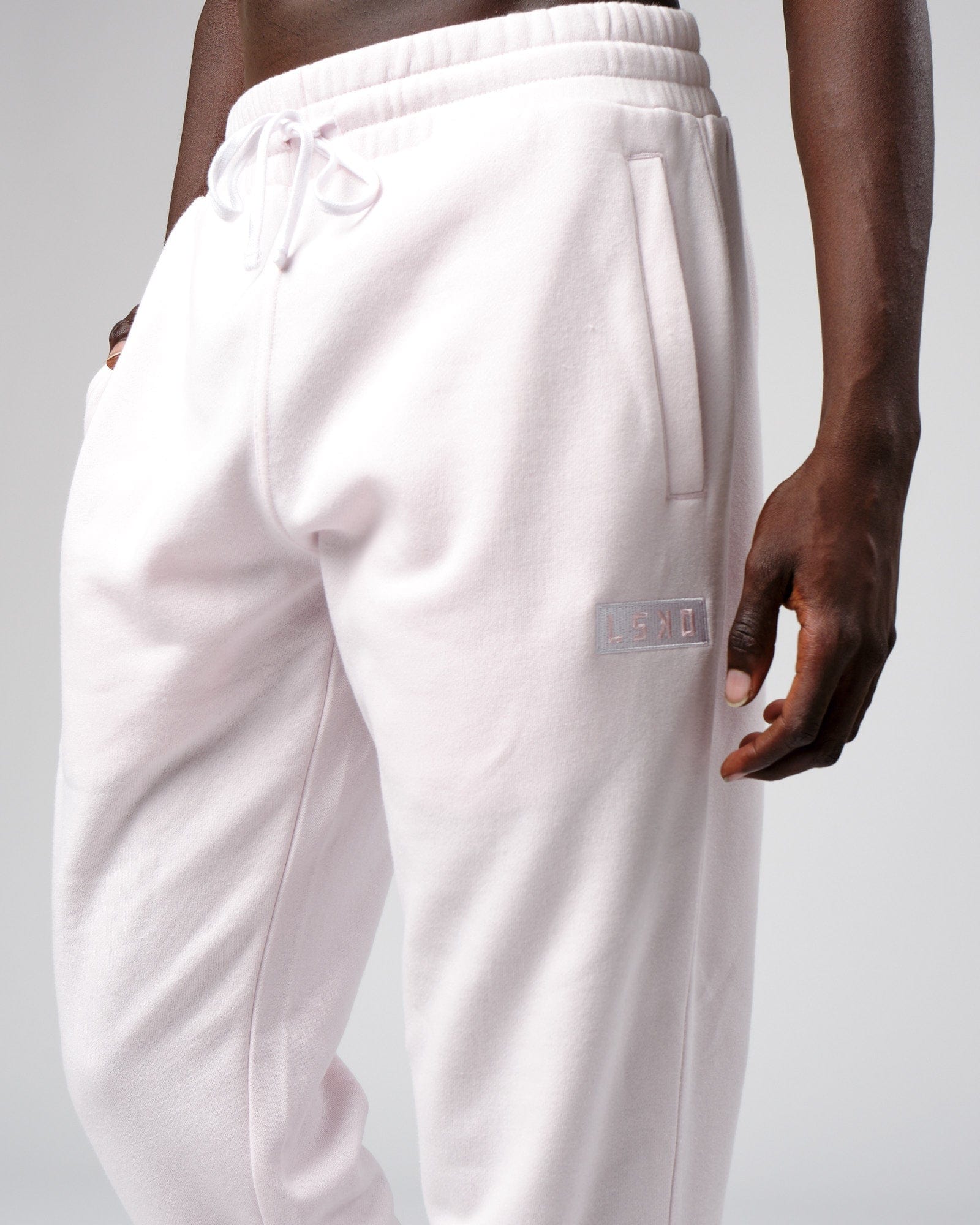 Model wearing Cornerstone Track Pant Oversize - Orchid Ice