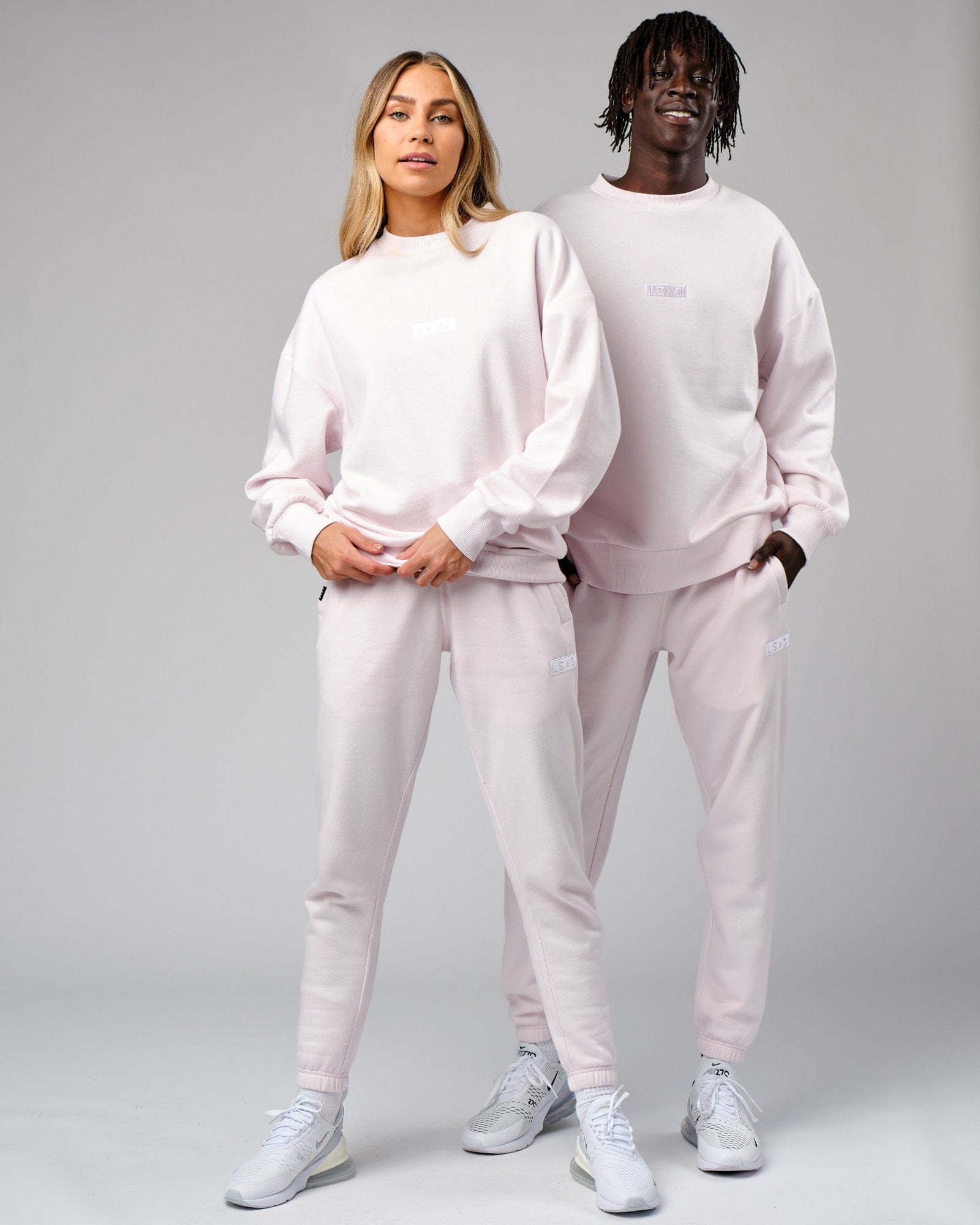 Model wearing Unisex Cornerstone Track Pant Oversize - Orchid Ice